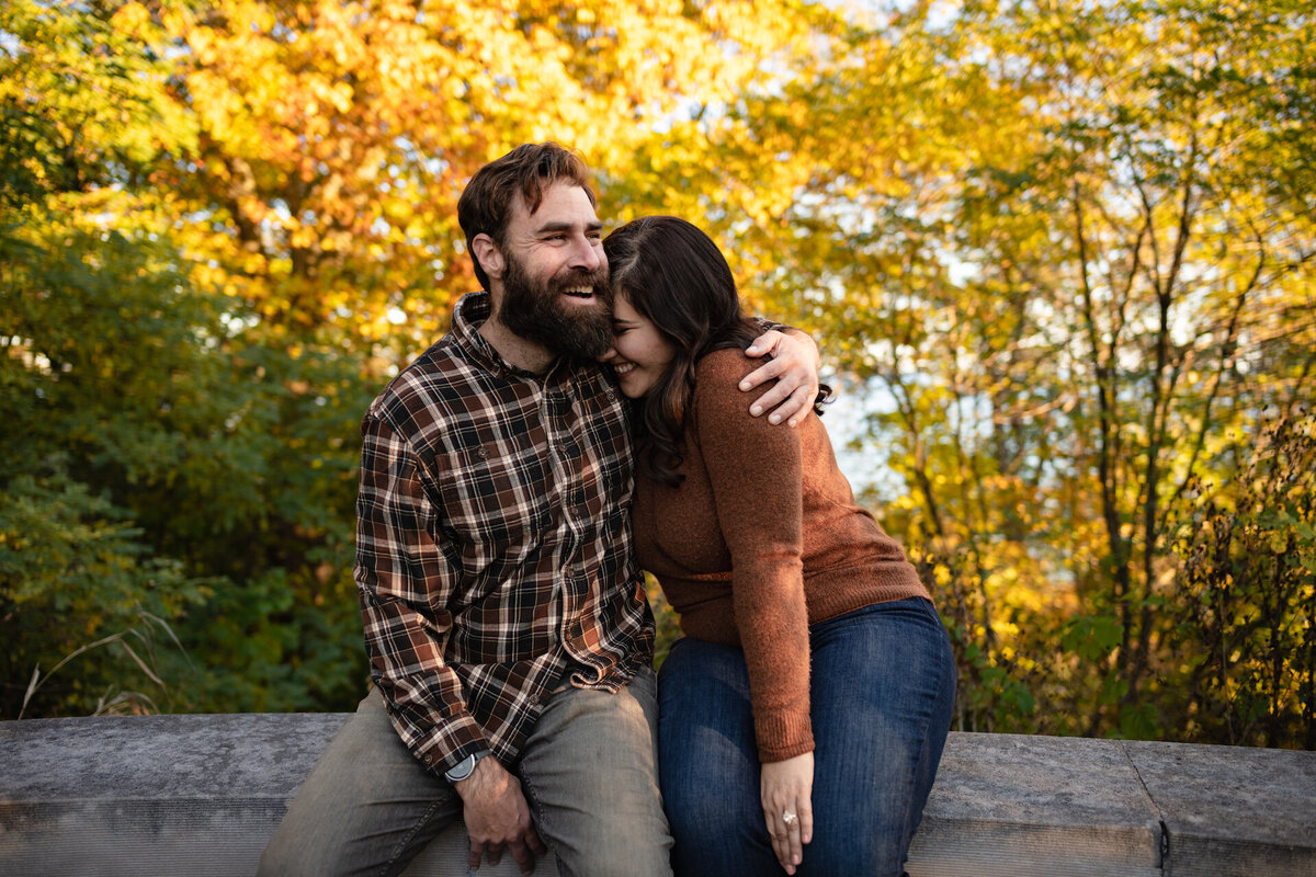 A couple side hug in a park during fall