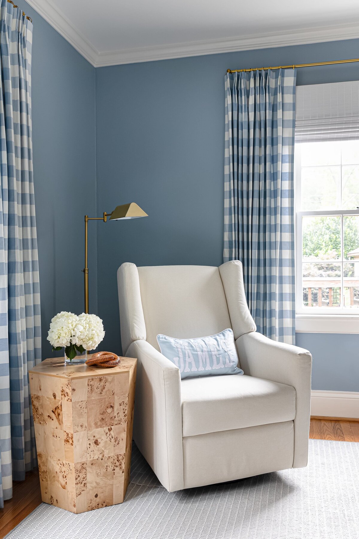 melinda chesson interiors bay street nursery with blue and white checkered curtains and white chair