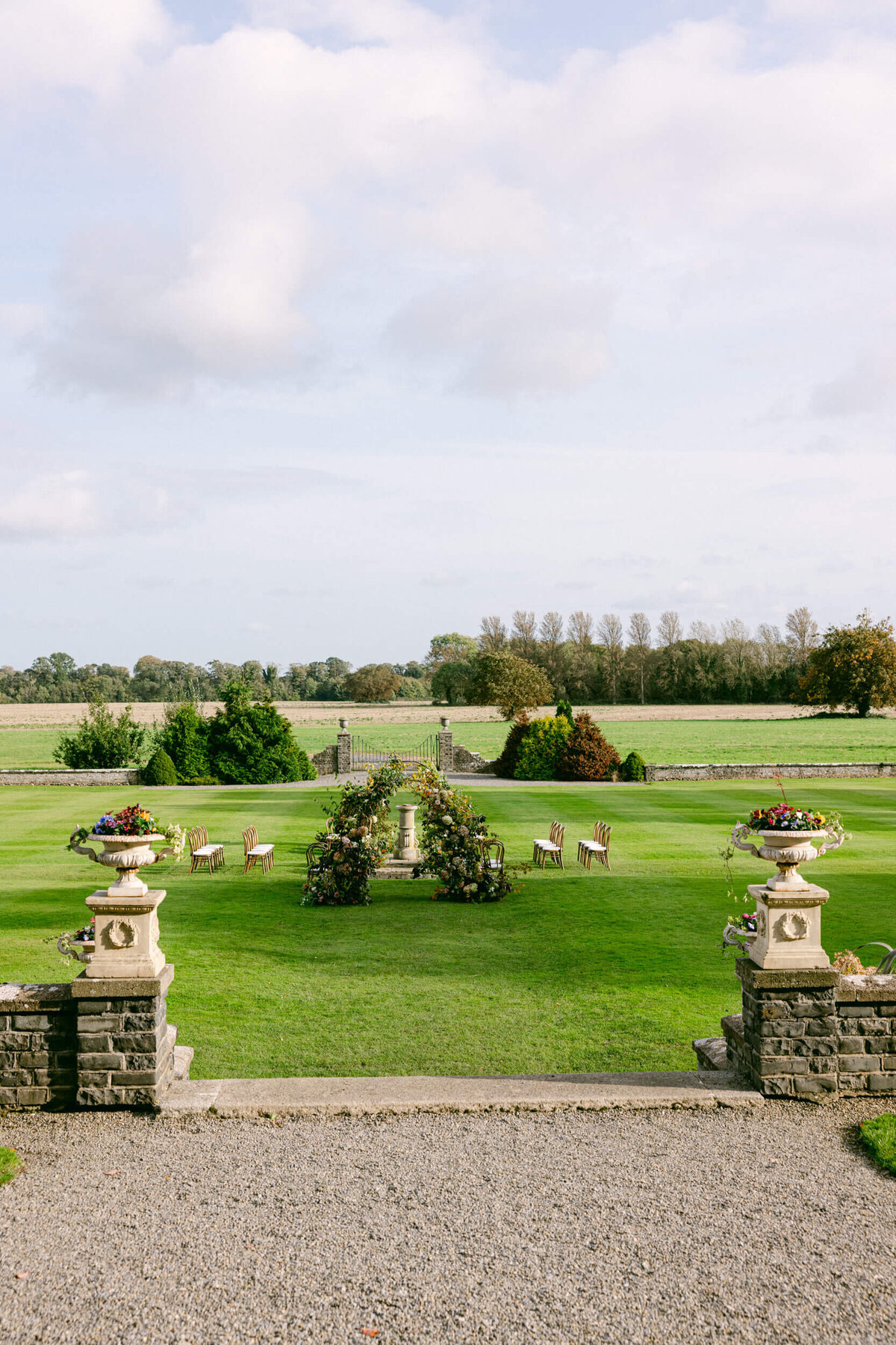 A wedding photo of the ceremony area in the gardens of Luttrellstown Castle in Dublin Ireland