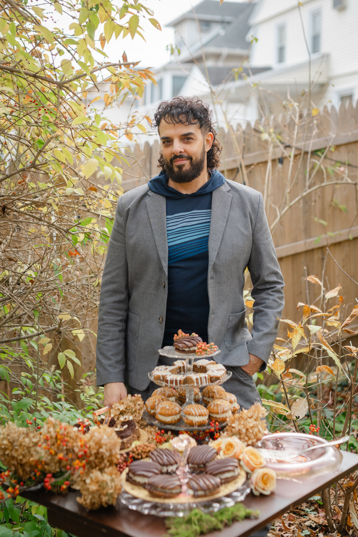 Guy standing by fall-inspired dessert table
