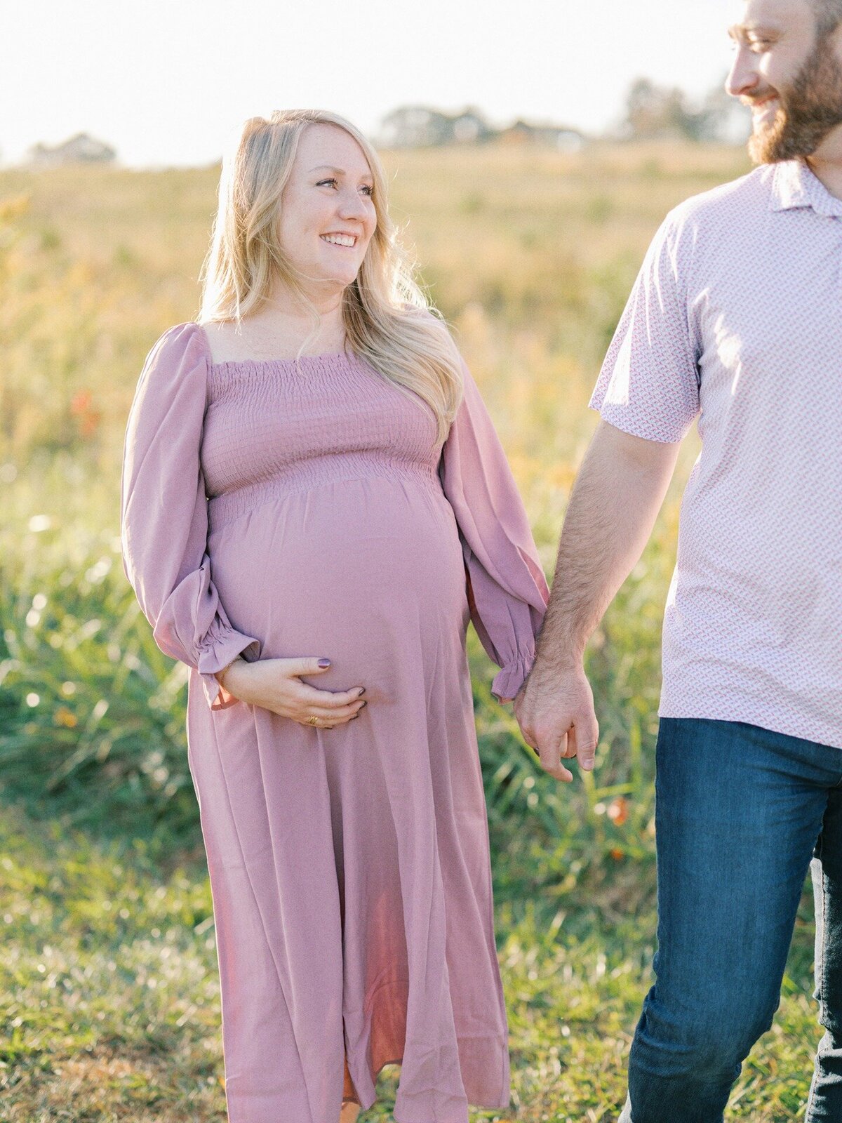 expecting-mom-walking-hand-in-hand-with-husband