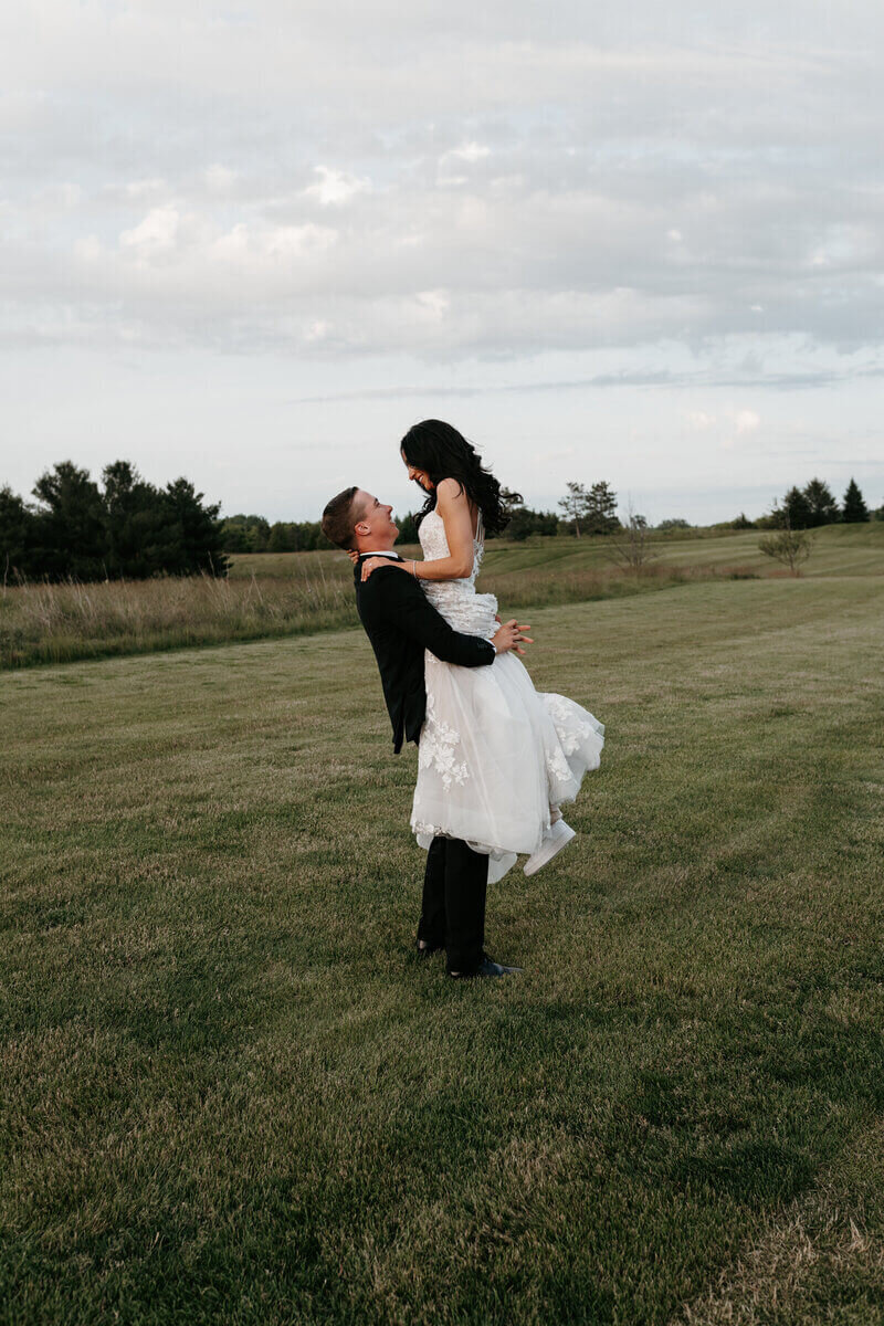 Bride and groom in field planned by wedding planners in chicago