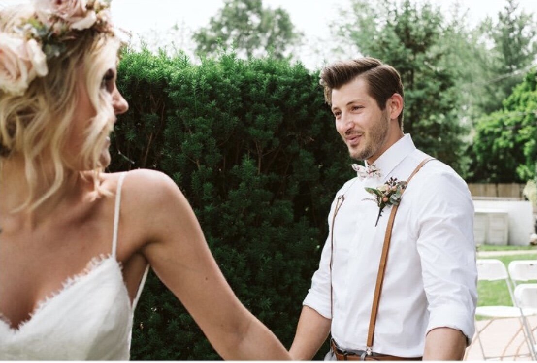 Bride and Groom holding hands at backyard wedding