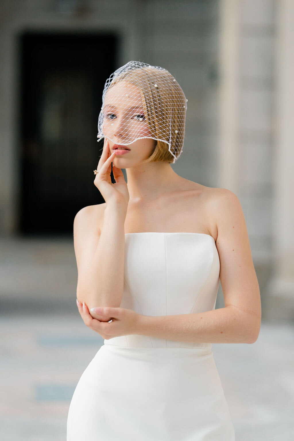 Short birdcage veil handcrafted with fine netting for a classic bridal look
