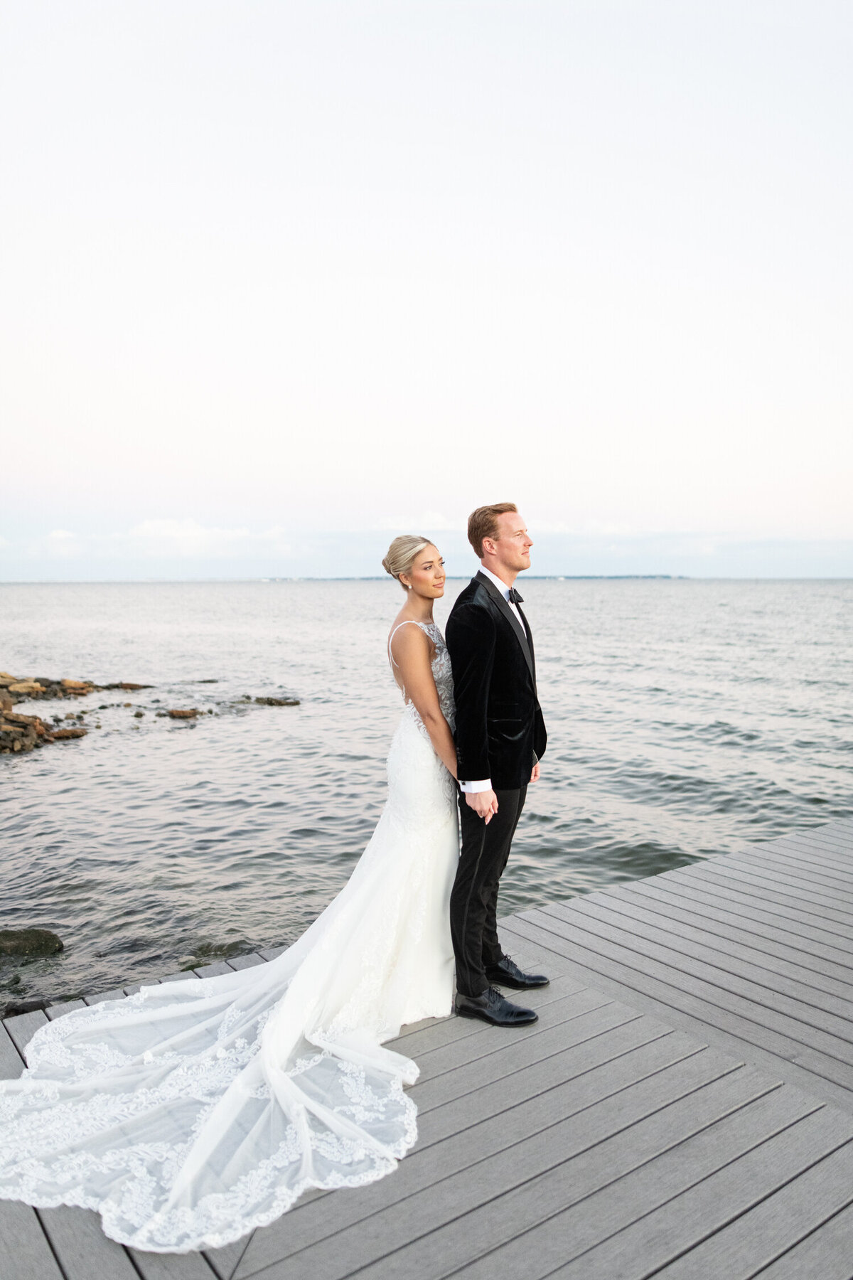 Sunset water pier bride and groom