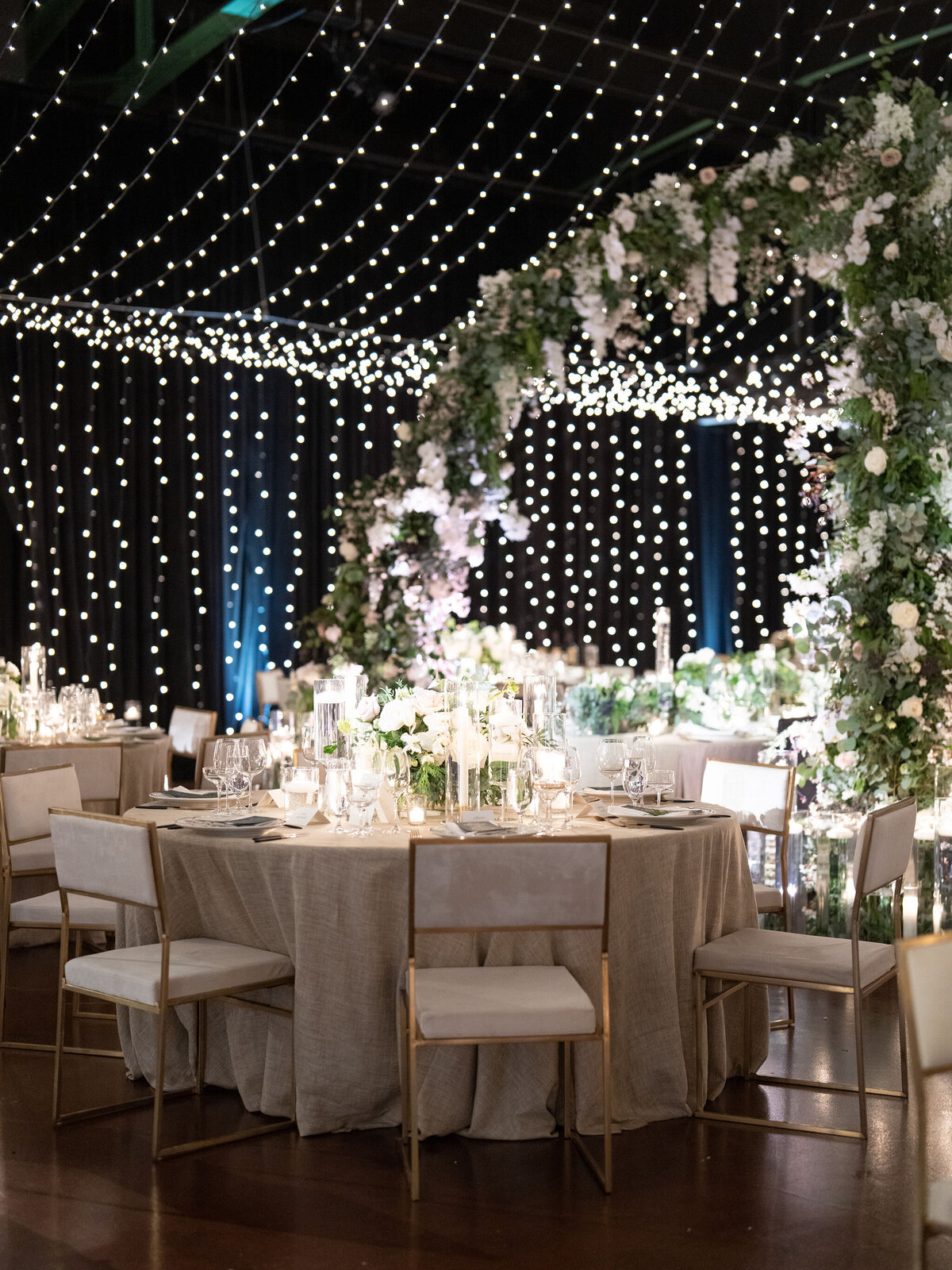 A Romantic Wedding Reception with Twinkling Lights and Elegant Florals.