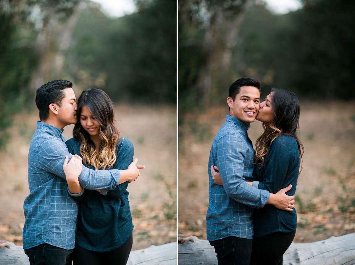 Engaged couple take turns kissing each other's cheeks