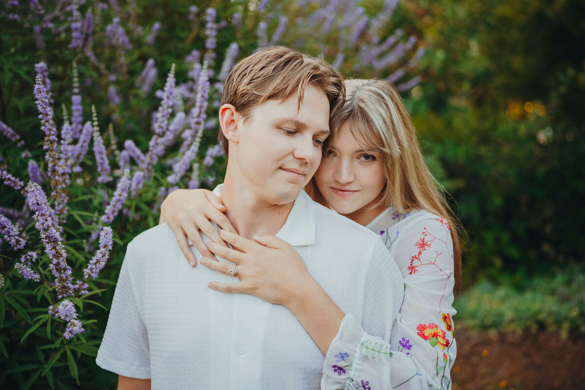 an engaged woman hugging her fiance