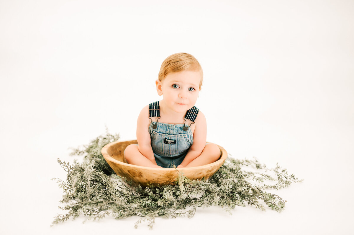 Springfield MO kids photography of kid sitting in bowl in overalls