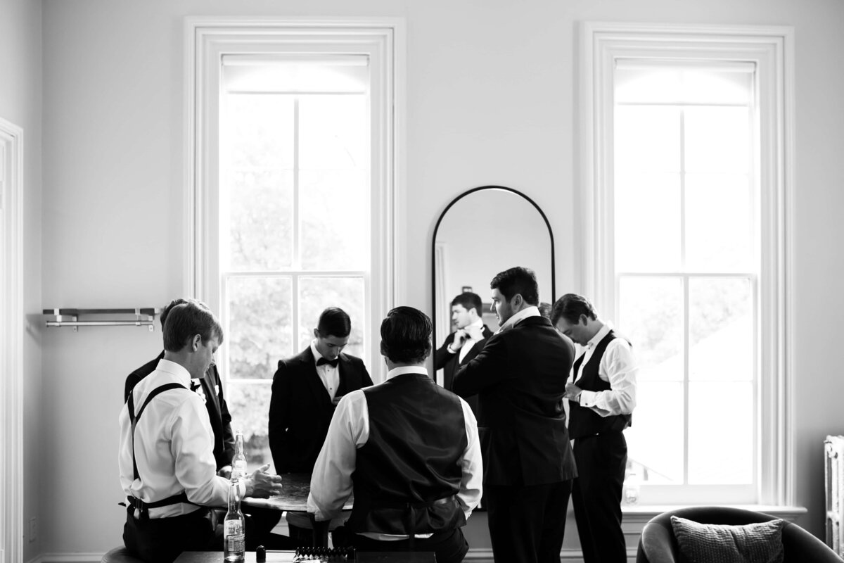 Candid photo of the groom and groomsmen in the groom’s quarters at the Merrimon-Wynne House Raleigh,NC