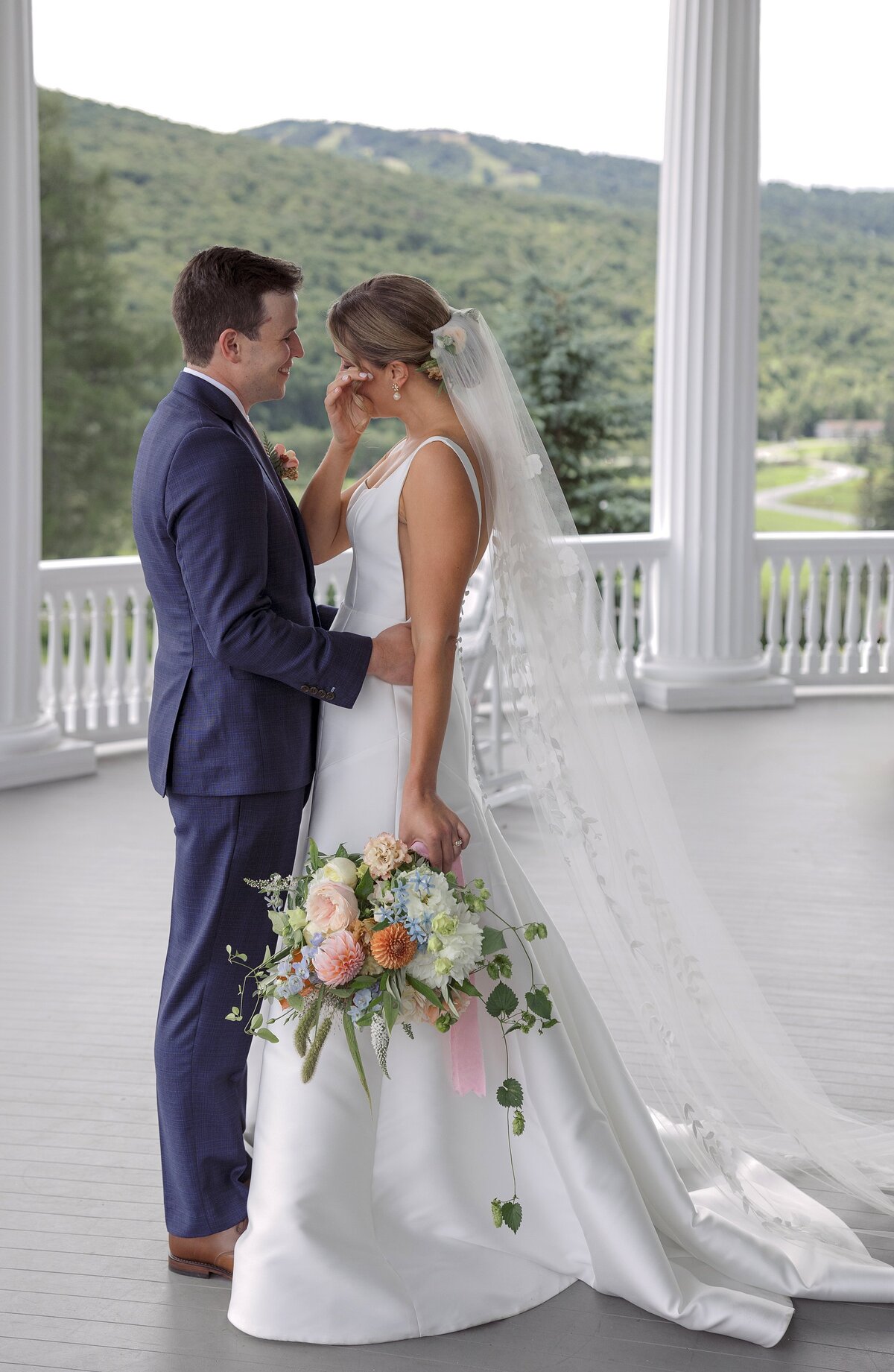 Bride cries as she sees Groom on porch of Omni Mount Washington Hotel