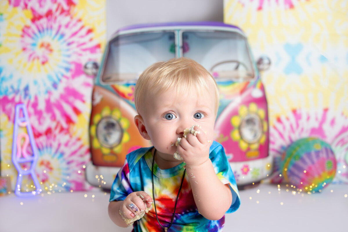 Little boy eating cake during cake smash photoshoot in Nashville, TN
