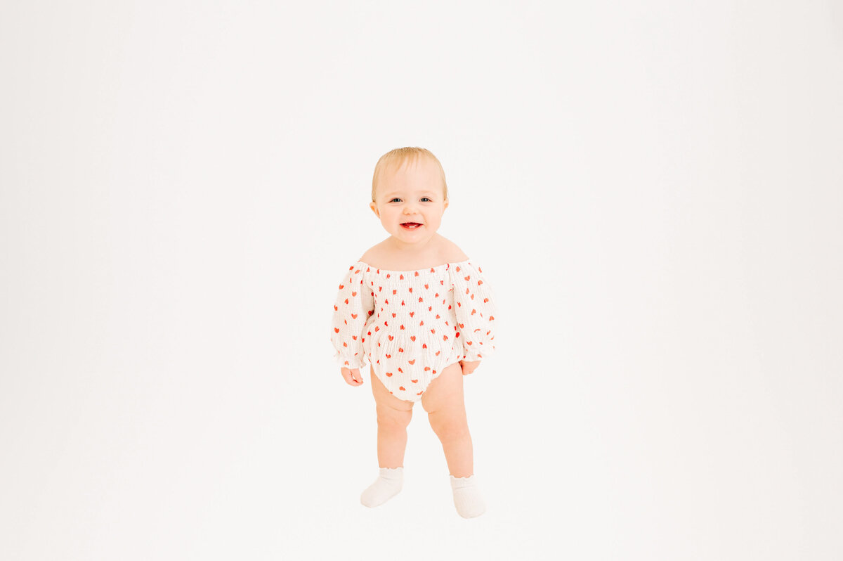 Toddler girl laughing indoors during Springfield MO kids photography session