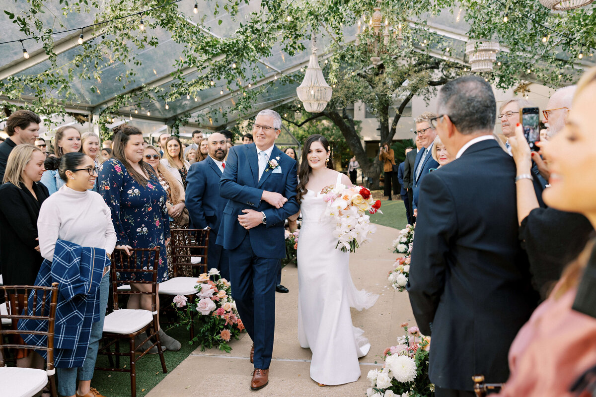 Colorful wedding ceremony arch by Posey Designs at The Four Seasons Austin