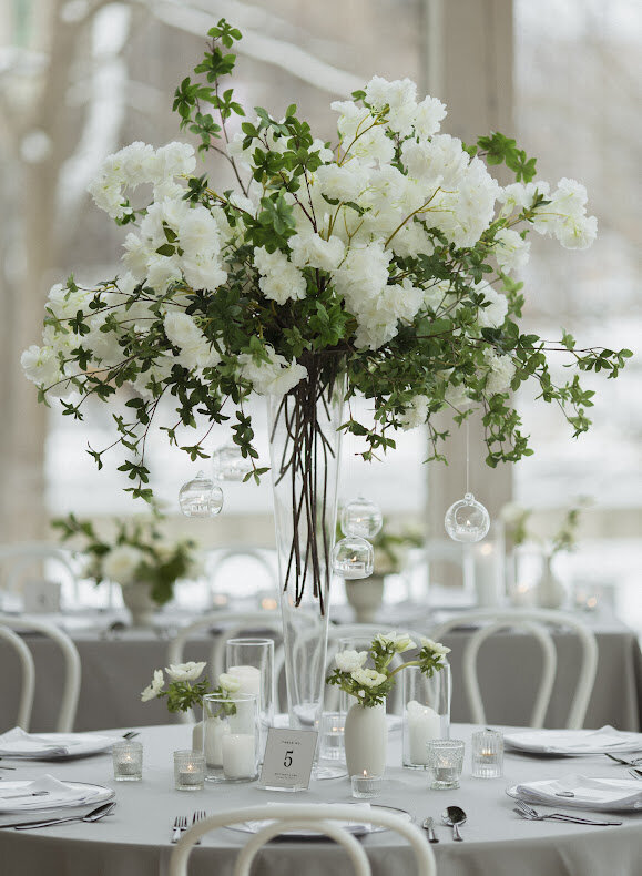Tall Tree Branch Centerpiece with White Cherry Blossoms  on a Wedding Guest Table