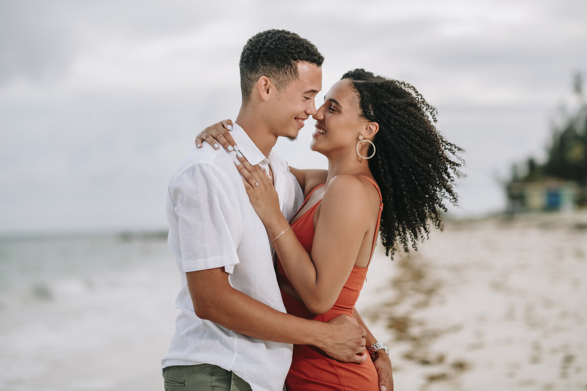 Engagement photos with couple having fun on beach