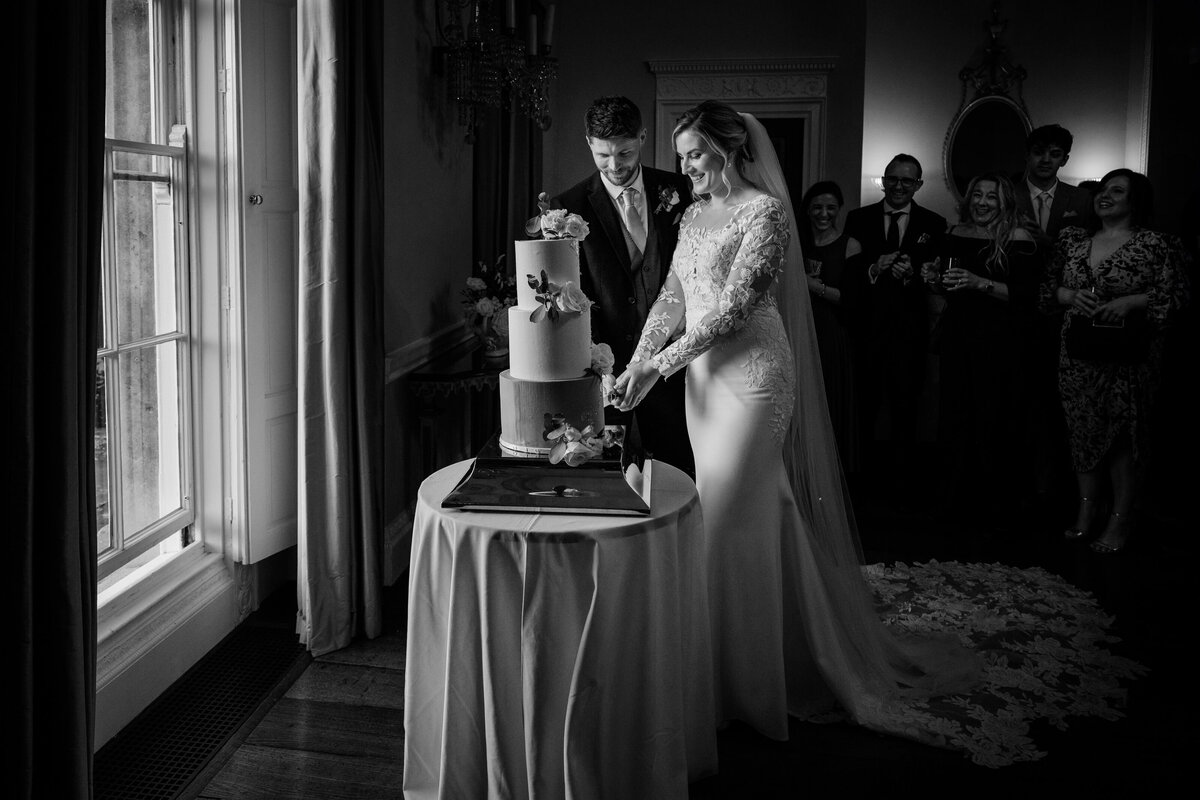 Bride and groom cutting their wedding cake 