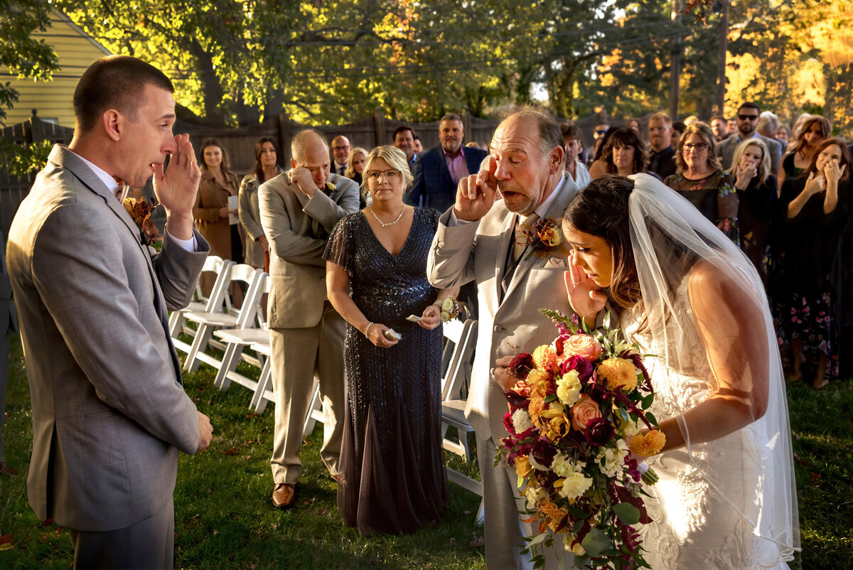 Family and friends all wipe tears as the ceremony begins.