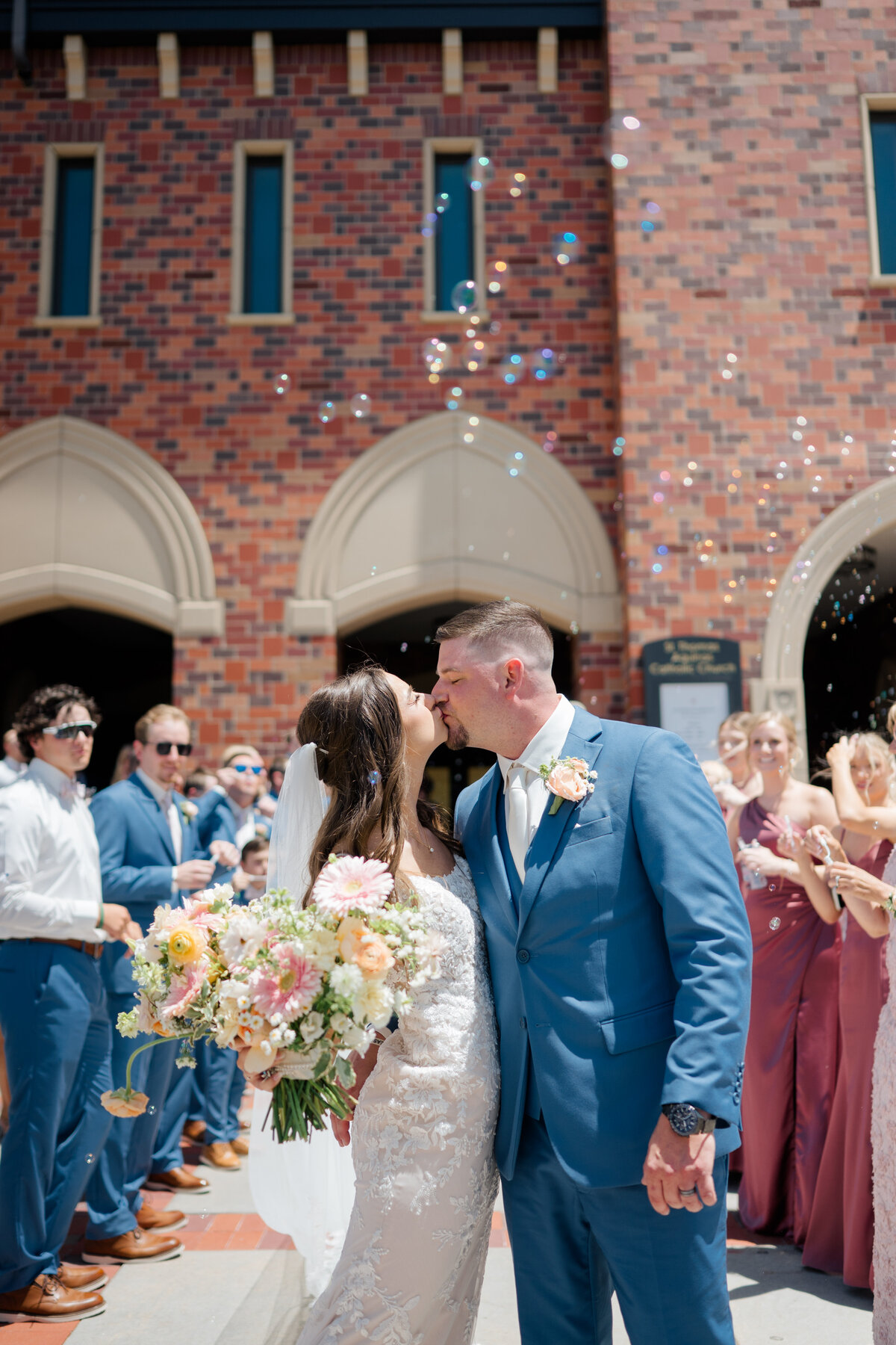Guests cheers and clink glasses at a wedding. Photo by Anna Brace, a Nebraska Wedding photographer.