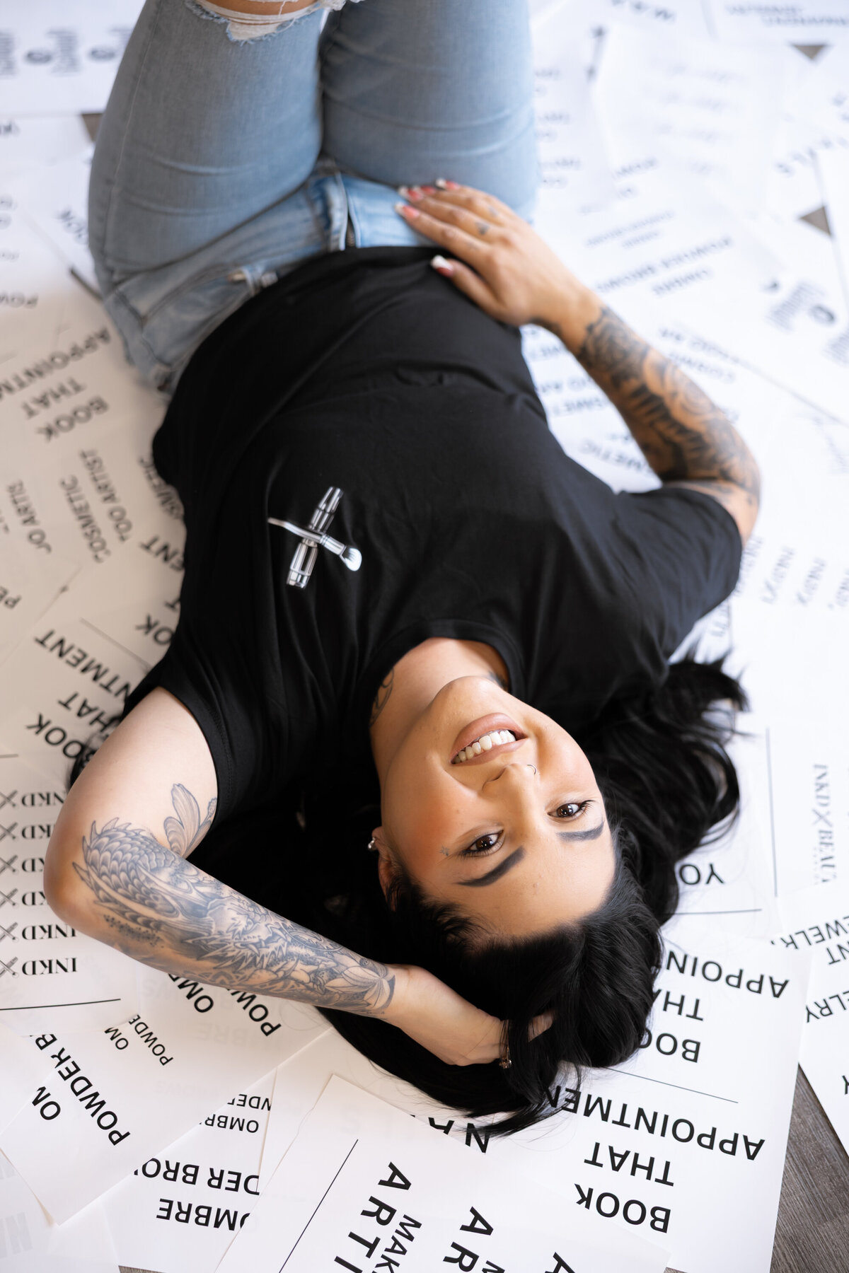 Professional beauty artist laughing while reclining on floor during branding photos. Photograph by Yucaipa branding photographer Kaitlyn Dawn Photography