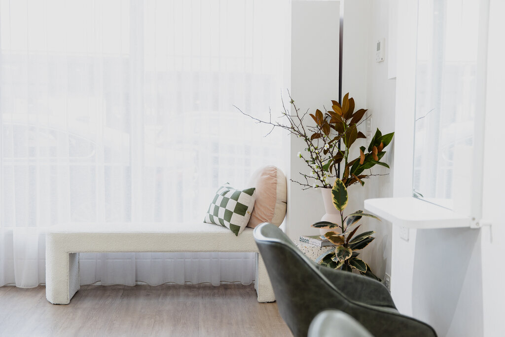 White resting chair with a Hair Salon Chair and a green plant