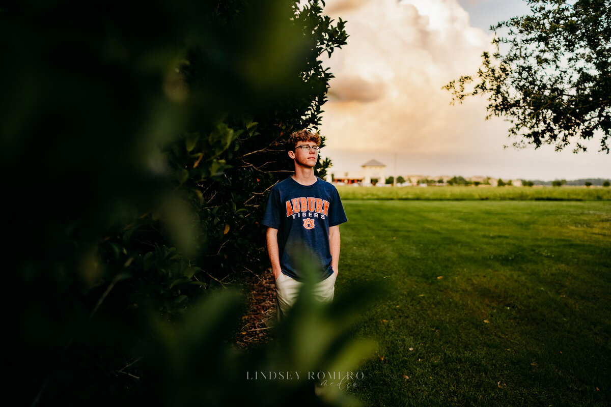 guy pose at sunset for graduation pictures in Youngsville, la