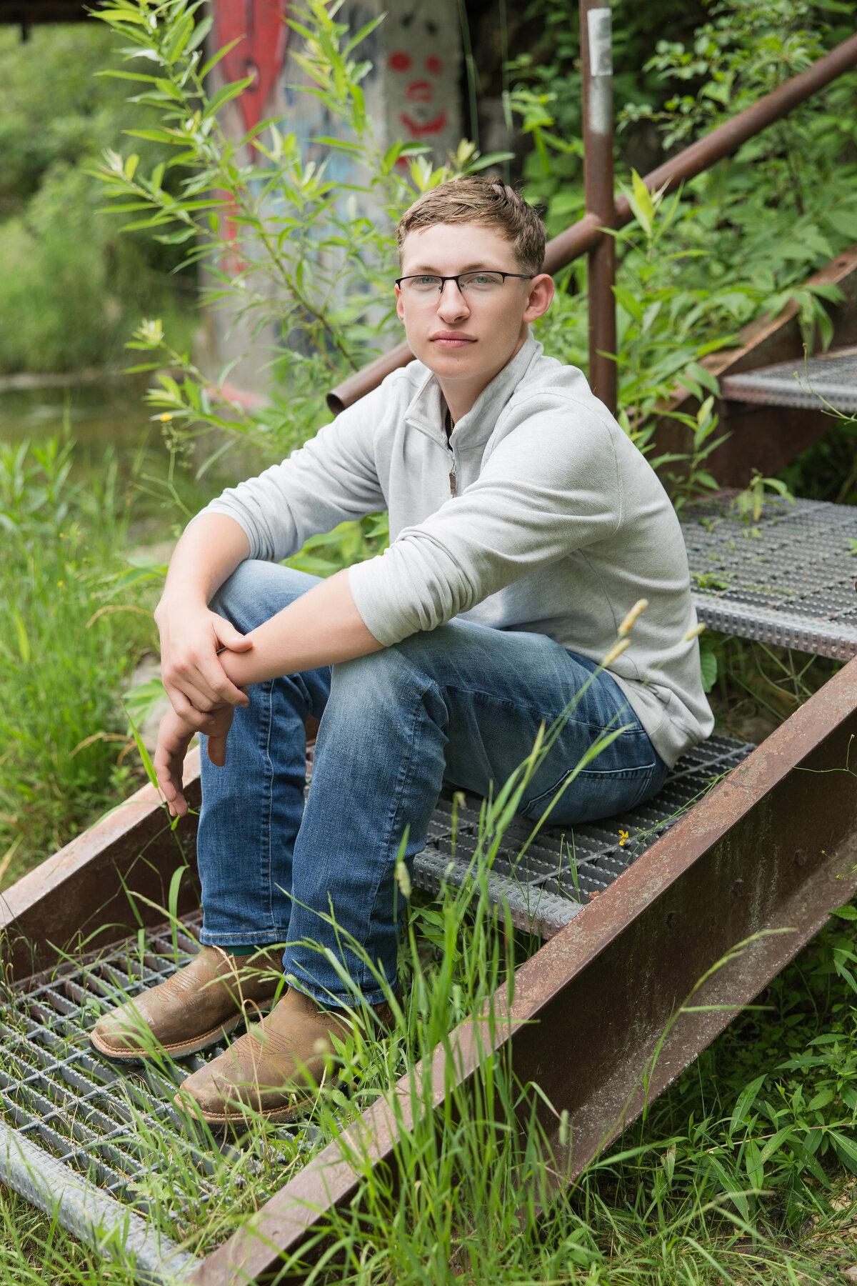 Senior guy sitting on steps looking at the camera