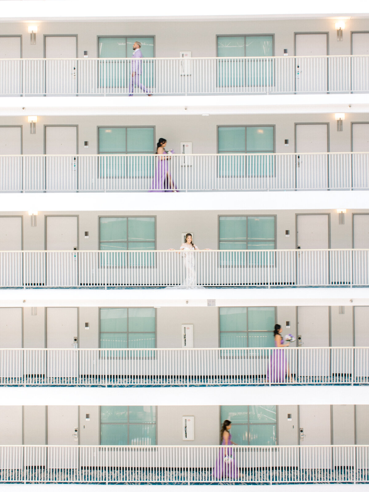 editorial shot of bride and bridesmaids on hotel balcony
