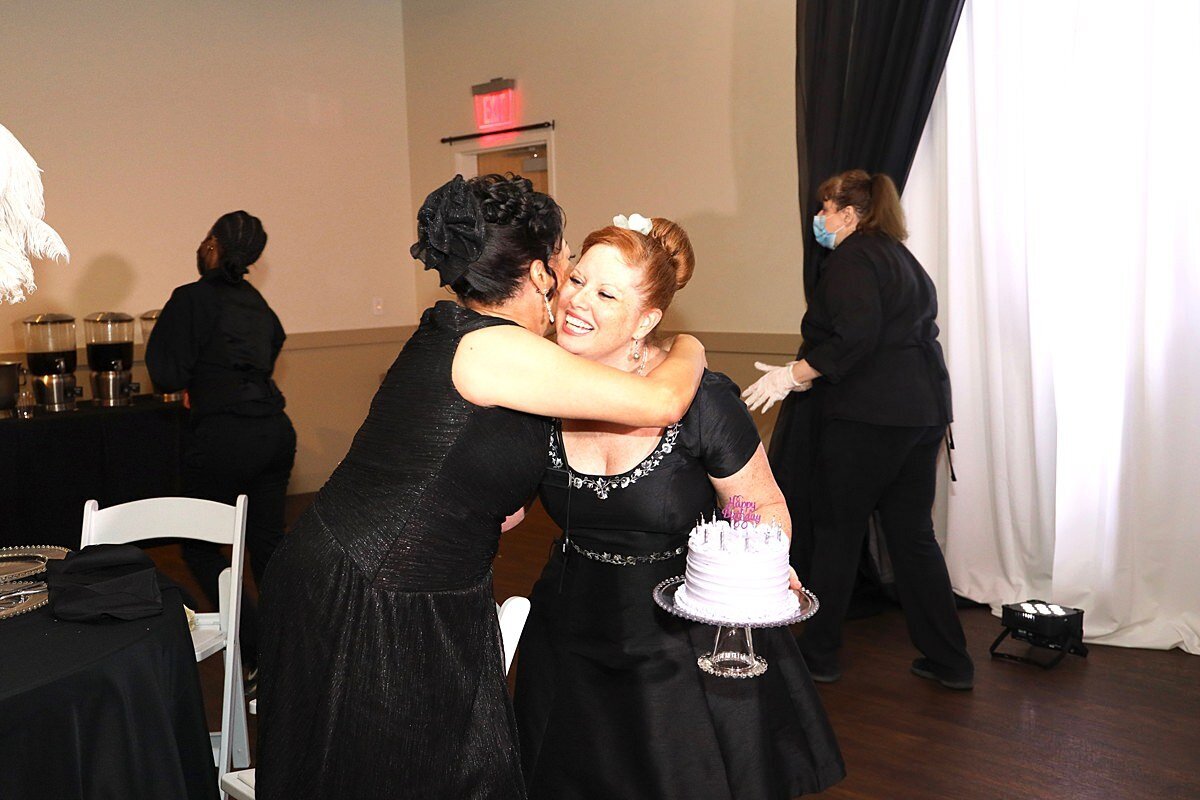 Clients love their wedding planners from Weddings & Events by Raina. Client hugs wedding planner.