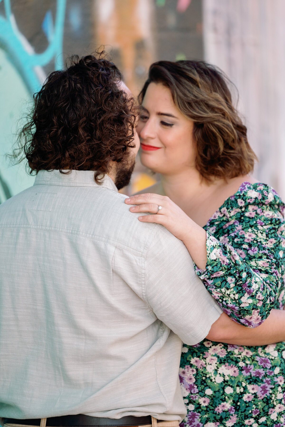 A couple with their arms around each other about to kiss