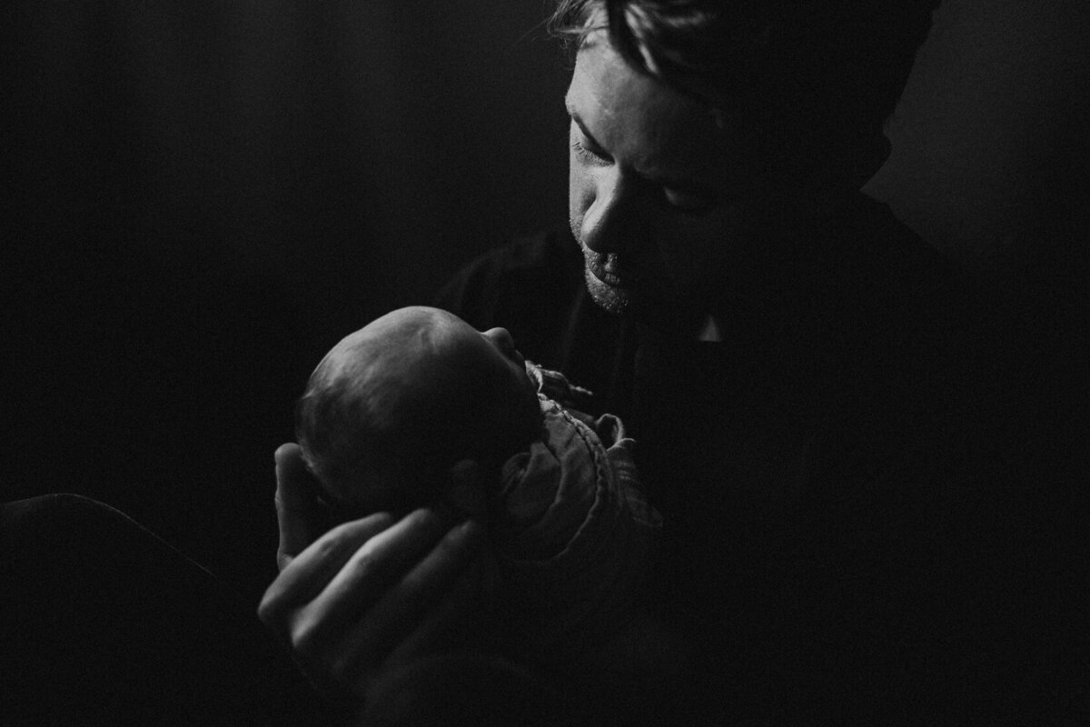 dad holding newborn baby