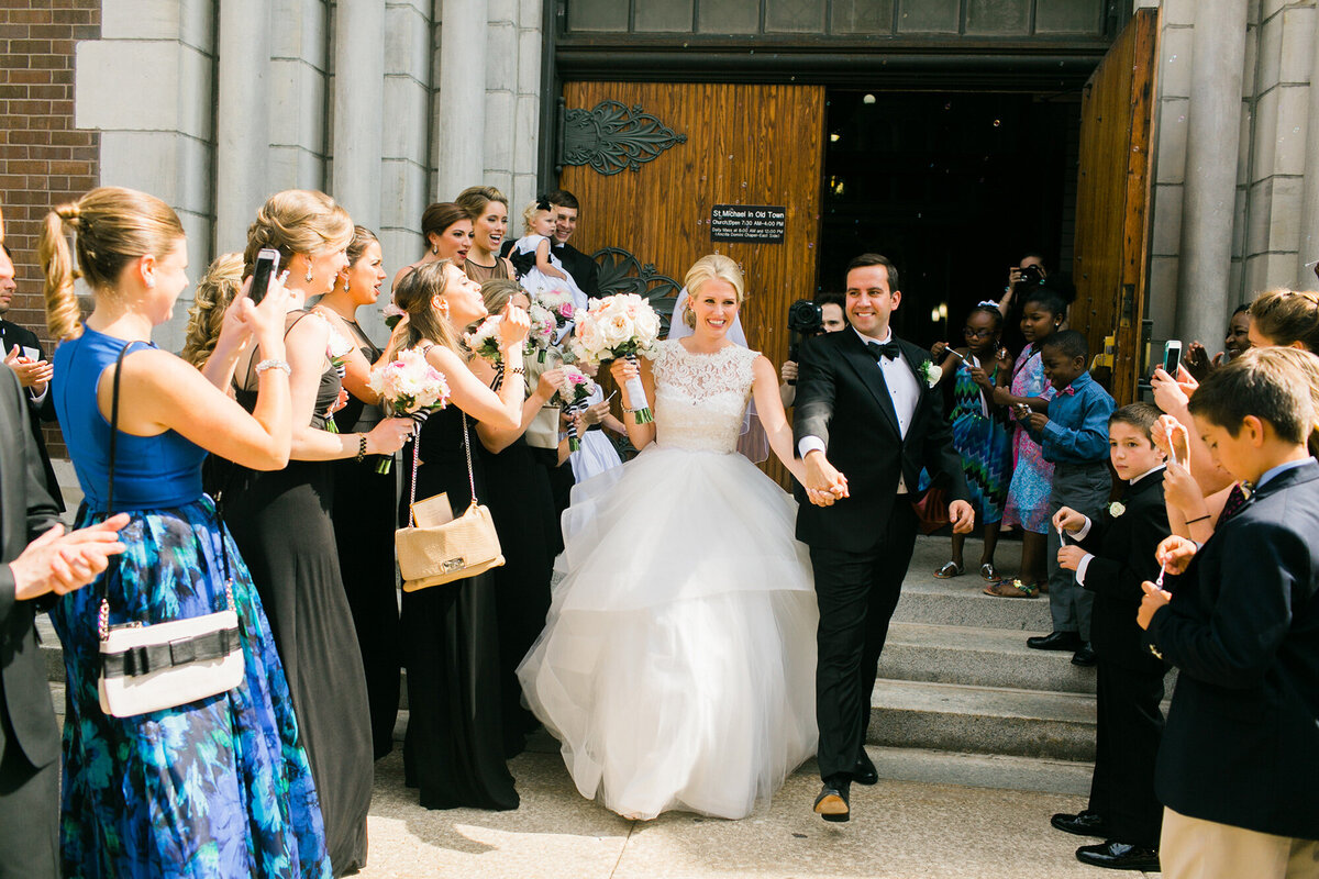 Guests cheer and congratulate newlyweds outside of St. Michael's in Old Town, Chicago.