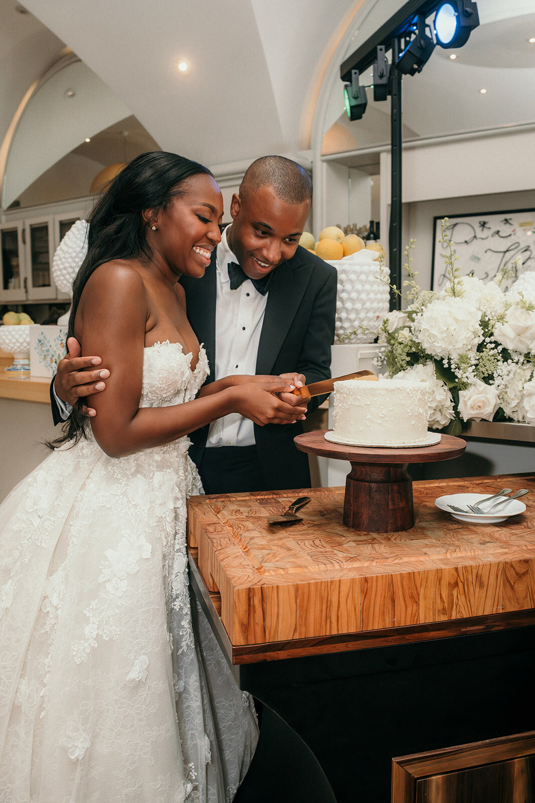 Bride and groom cut their wedding cake.