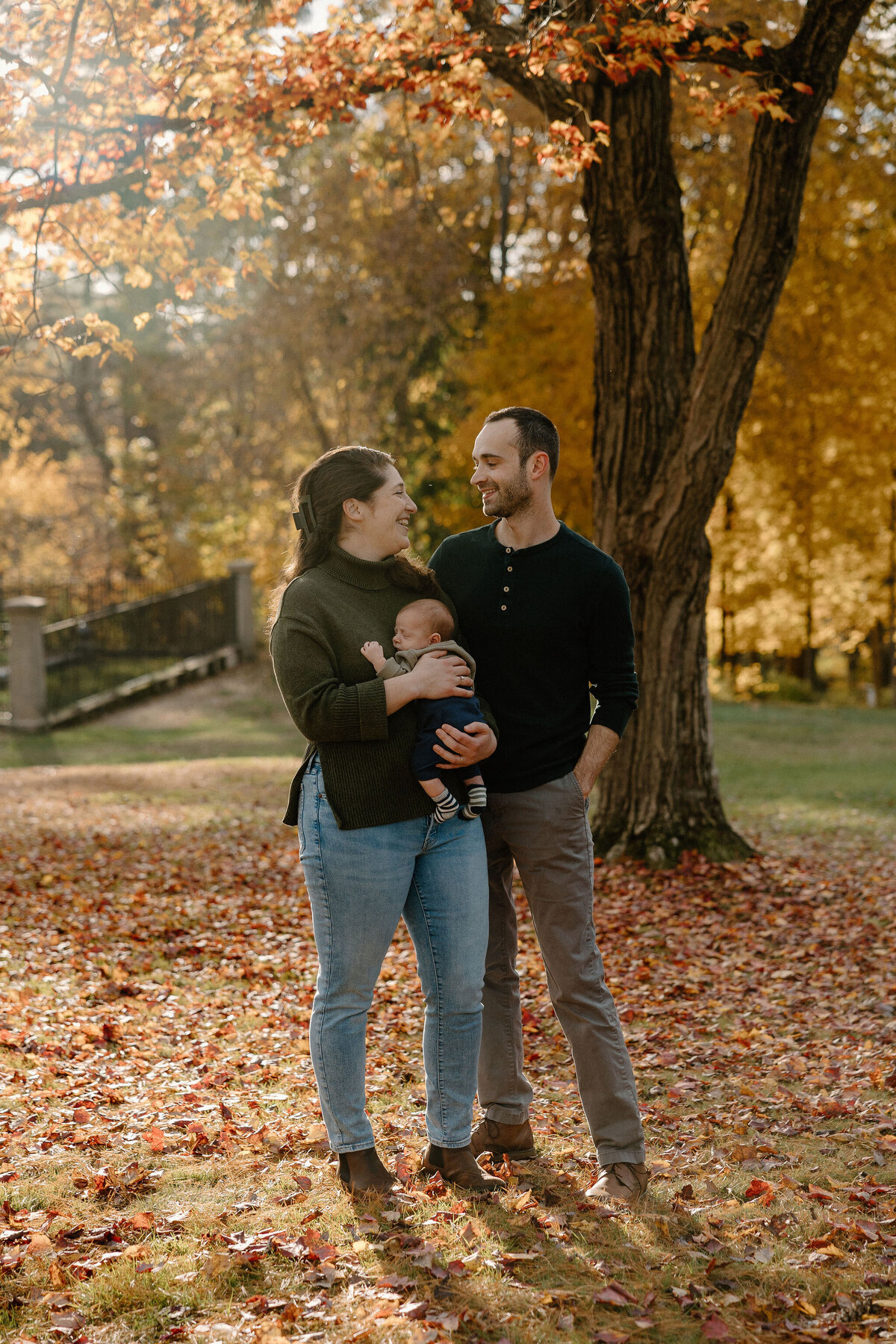 family smiling in fall