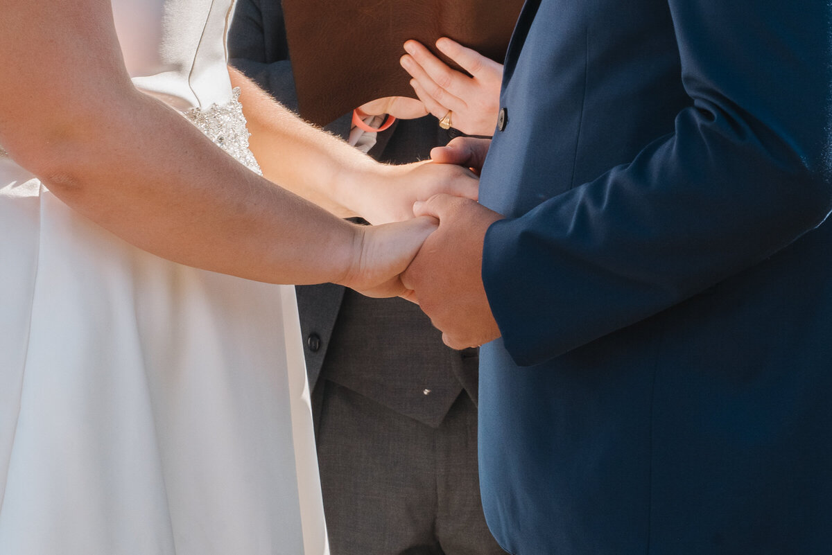 Bride and groom holding hands 