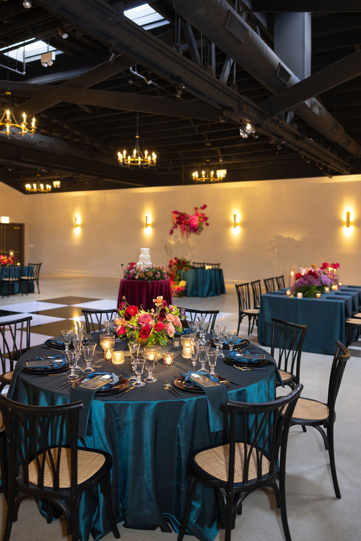 in house black and white dance floor in large reception space, timeless space with personalized floral and design