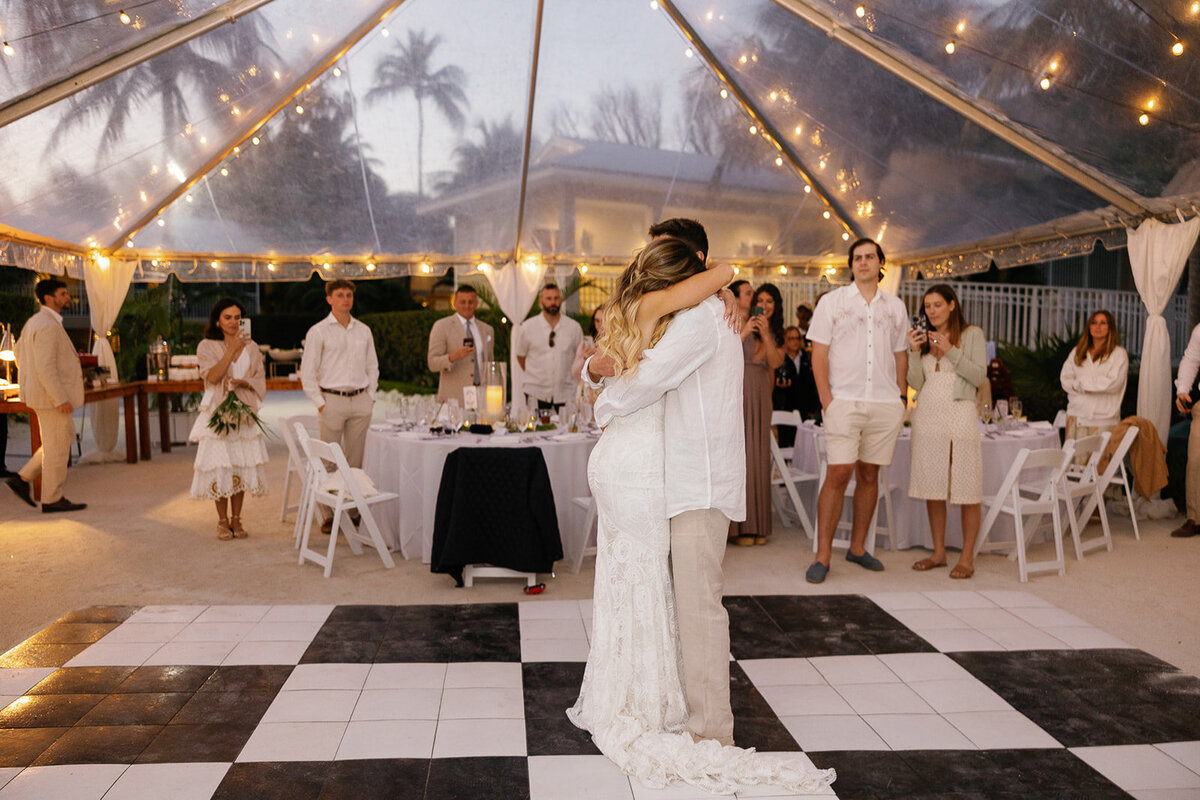  Bride Laura and groom Abraham dancing joyfully at their destination wedding reception in Miami.