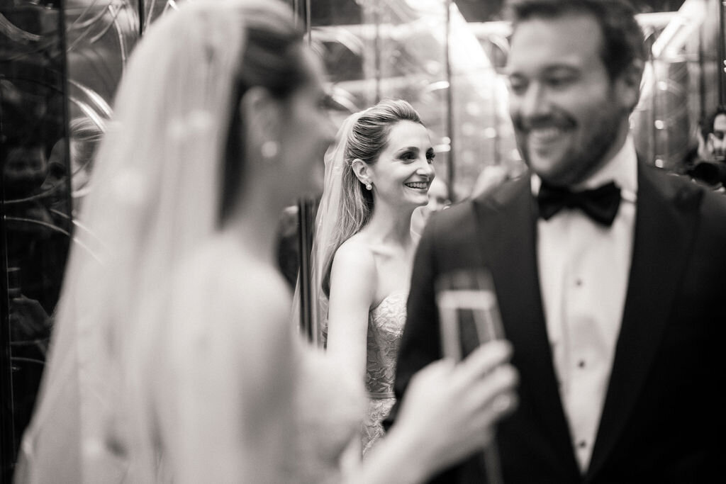 Close up of the bride and groom holding a glass of Champagne. 