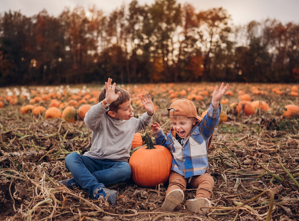 Brothers cheering at a pumpkin patch
