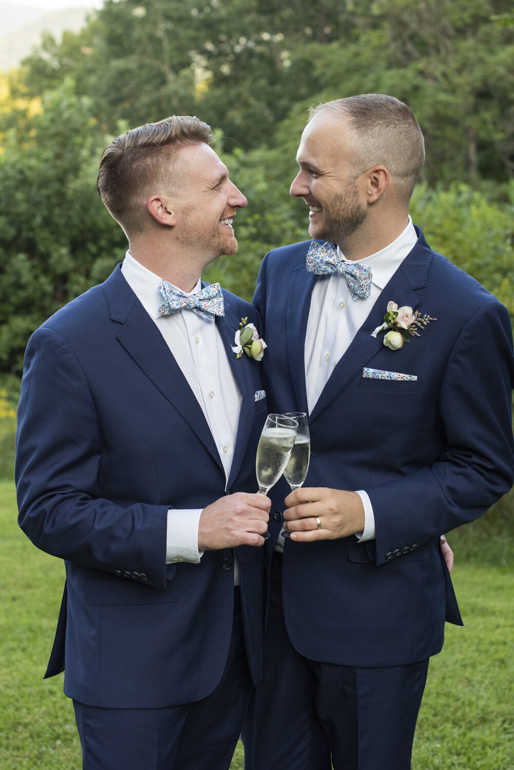 Queer couple smiling at Twisty Maple wedding