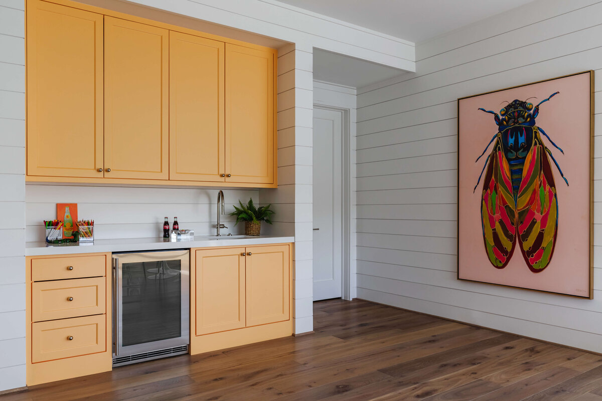 oyster creek studios memorial new build orange cabinets with large month painting in kitchen