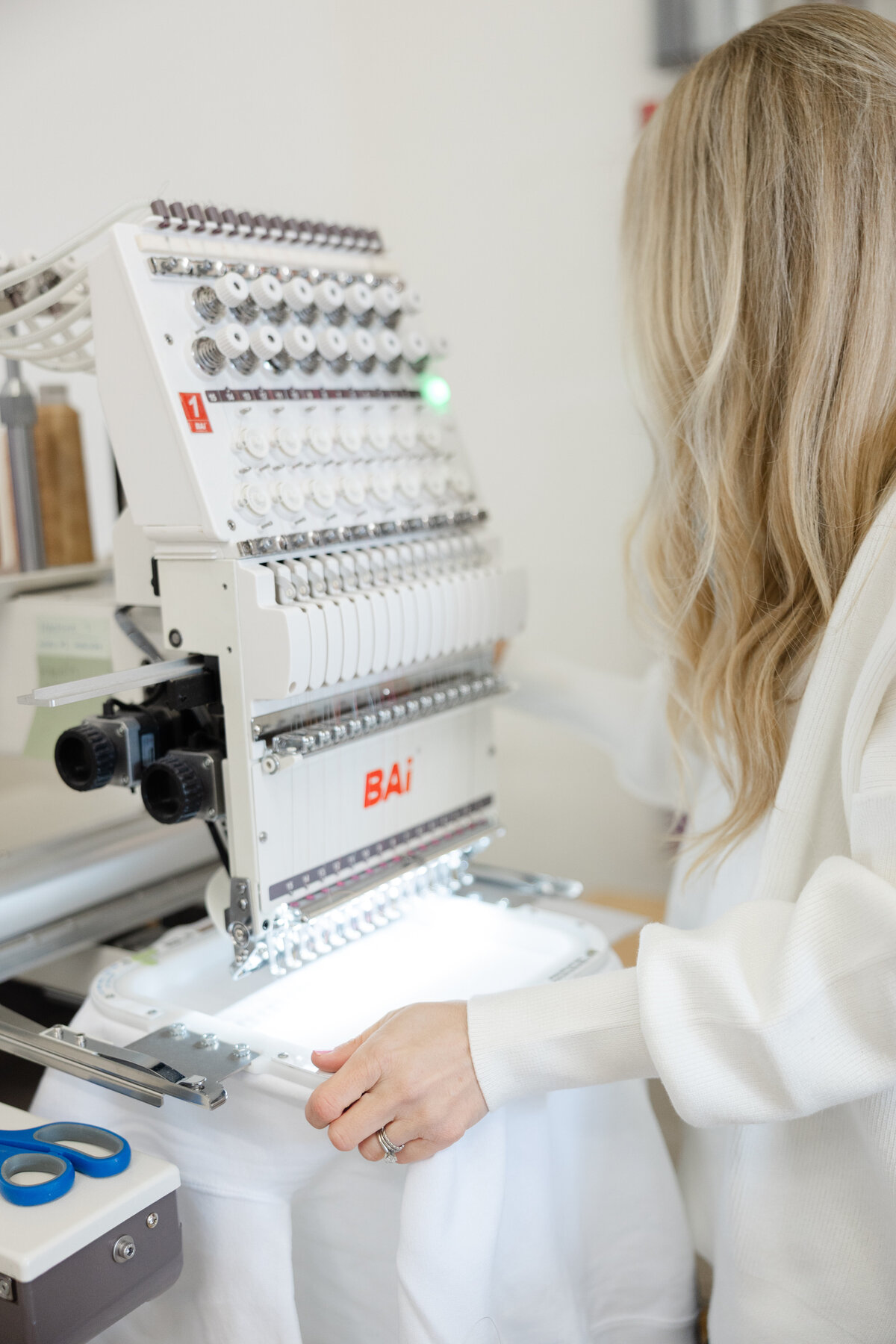 Close-up of embroidery machine producing a custom design. Photograph by Yucaipa branding photographer Kaitlyn Dawn Photography.