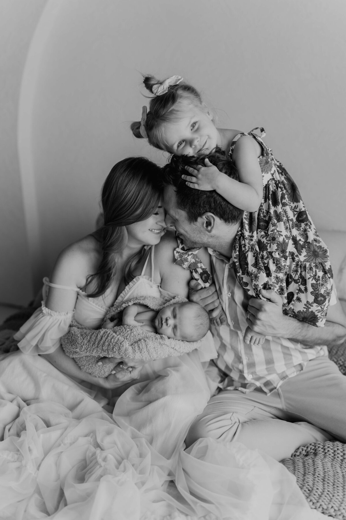 a stunning family photo  with a toddler and newborn