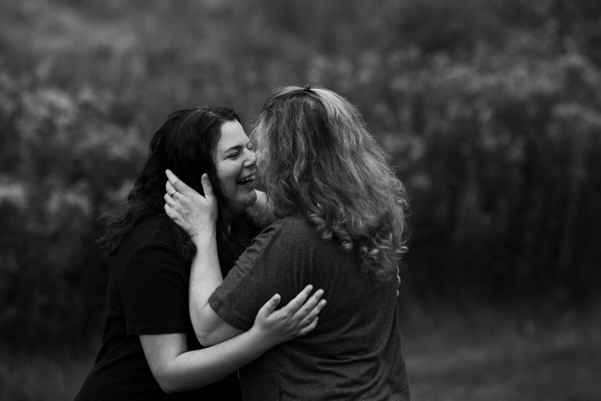 mom gives her senior a hug before the photo shoot