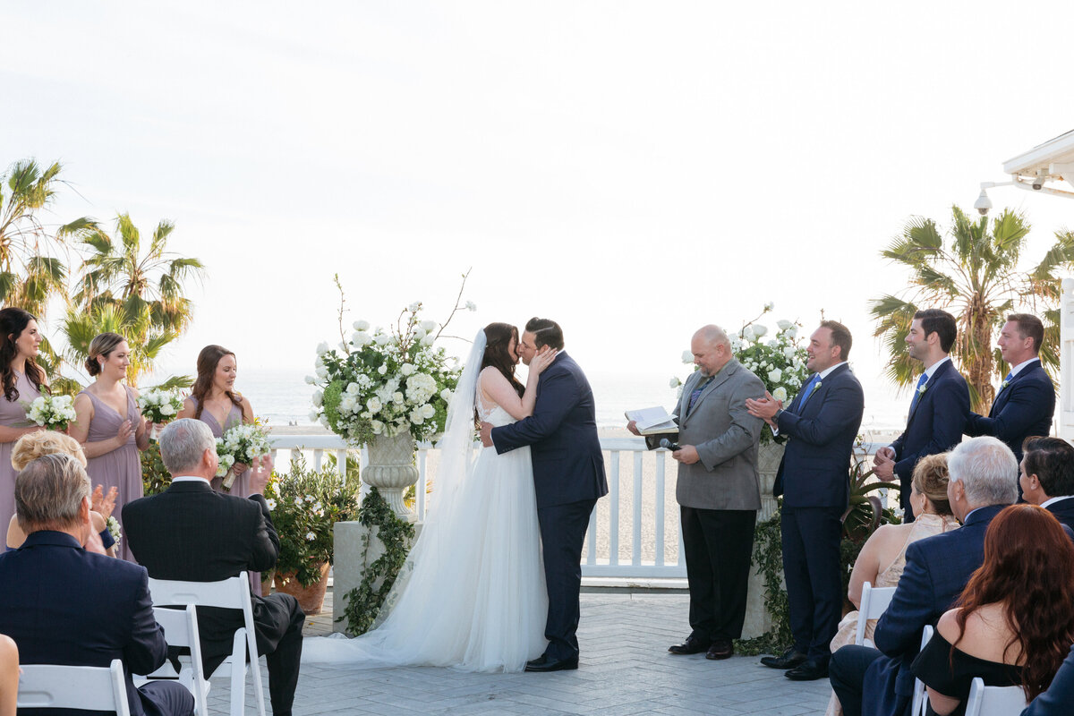 A bride and groom during their first kiss