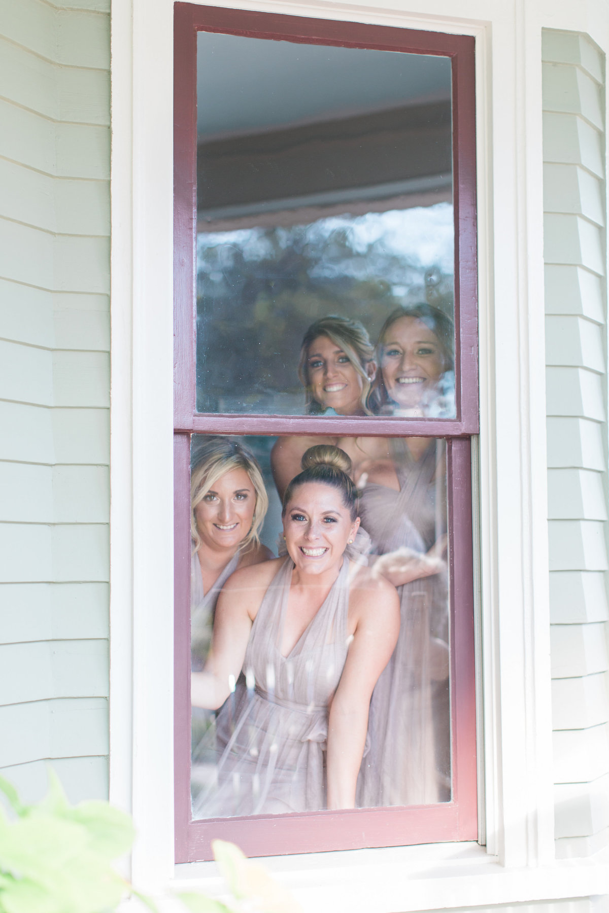 Bridesmaids looking out window at The Oyster Farm