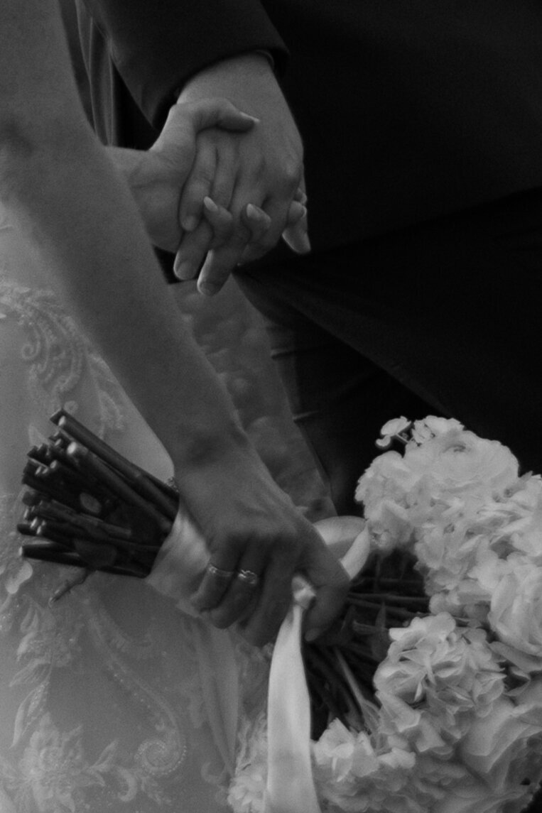 bride-and-groom-holding-hands-with-bouquet