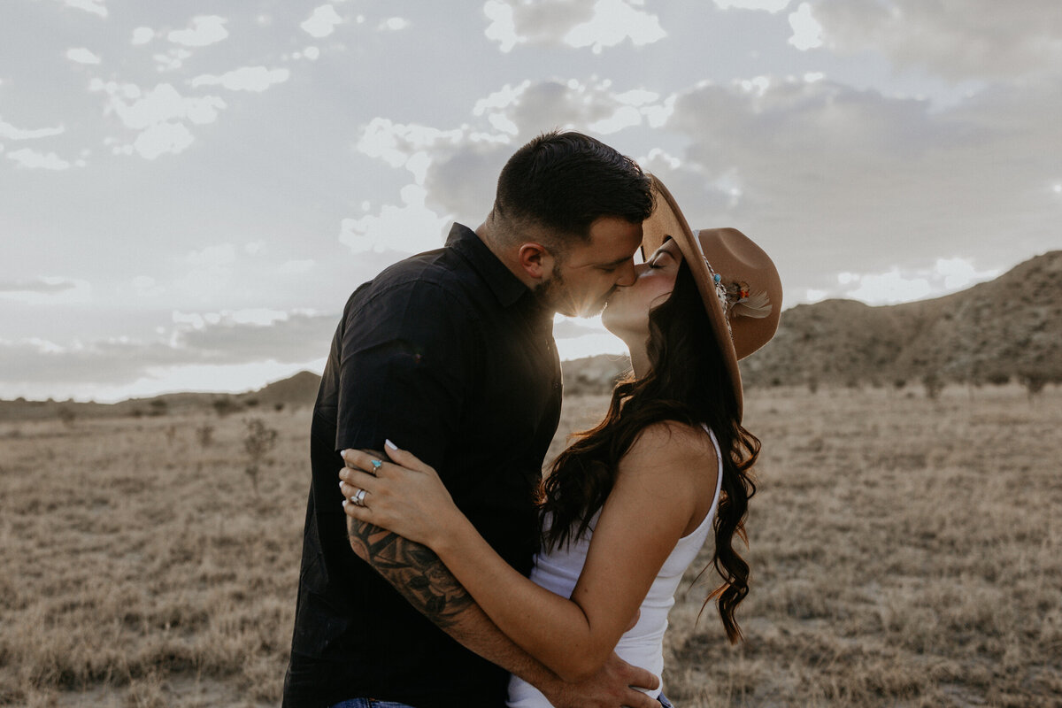 man holding his fiancé about to kiss her