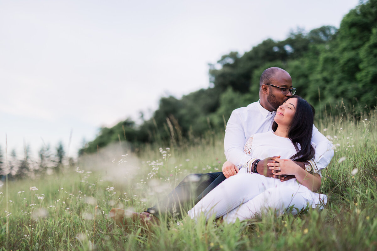 Engagement photo in a field by Box Hill Mansion