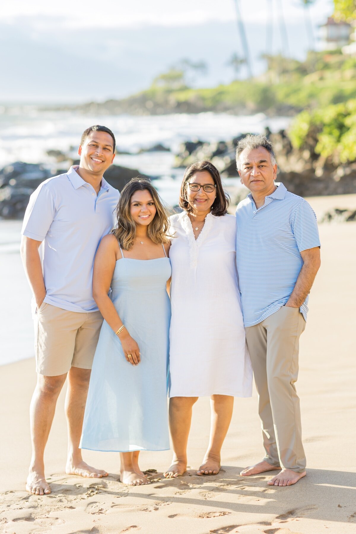 Family is dressed, nice in light, blues and white with tan khaki shorts and pants.